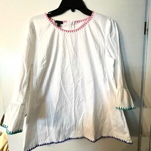 Talbots.  Beautiful white blouse with embroidery and zipper back.